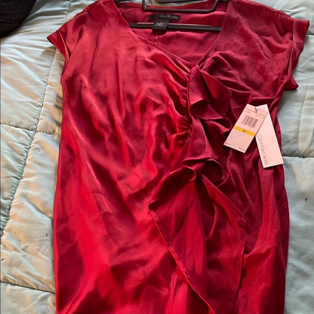 Calvin Klein Scarlet Ruffle top with ruffles down one side.